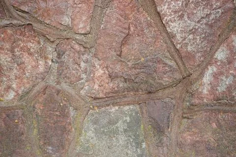 Real stone wall surface with cement, stone background. Stock Photos