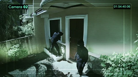Real surveillance cameras captured and recorded the two robbers enter the house. Stock Footage