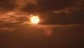 Real time aerial setting sun hides/emerges behind clouds and heavy fog HD Footage