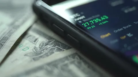 Real-time analysis of the cryptocurrency market in a smartphone. dollar bills. Stock Footage 236477048