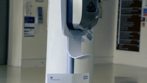 Real time, close shot of hands taking gel sanitizer from dispenser Stock Footage 127382917