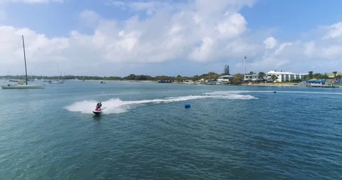 Real time different movement aerial footage of water jet ski boat sailing Stock Footage 99397063