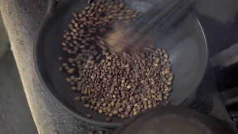 Real time foootage of hand coffee roasting in iron pot Stock Footage 259505380