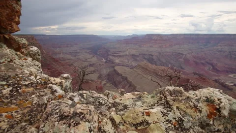 Real time forward tracking shot over a cliff edge revealing the Grand Canyon Stock Footage 149999711