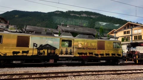 Real time golden GoldenPass Train du Chocolat locomotive at Zweisimmen railway Stock Footage 337957428