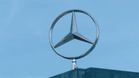 Real time locked down close up shot of spinning Mercedes-Benz Emblem in Berlin Stock Footage 67426564