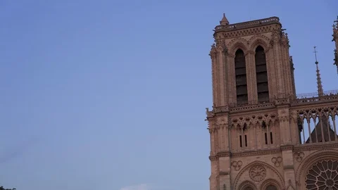 Real time medium shot of Notre Dame de Paris at sunset. Crowds of tourists near Stock Footage 113761166