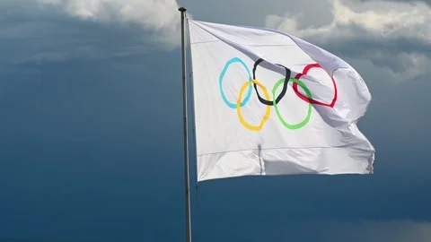Real Time of One Olympic flag beside Lake Geneva on cloudy day. Lausanne Stock Footage 336959956