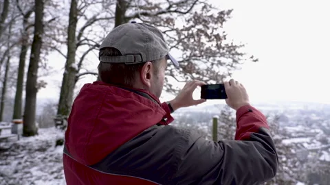 Real time panning shot of a speaking middle aged man in winter forest in Swit Stock Footage 146984153