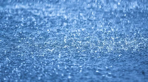 Real time raindrops falling on blue water, DOF Stock Footage 49836367