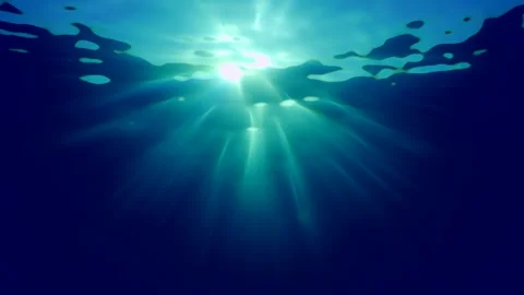 Real time, Sharp sunrays pierce blue water of ocean, Backlighting (Contre-jour) Stock Footage 247021185