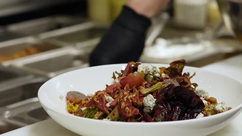 Real time shot as chef prepares vegetables salad Stock Footage 127601010