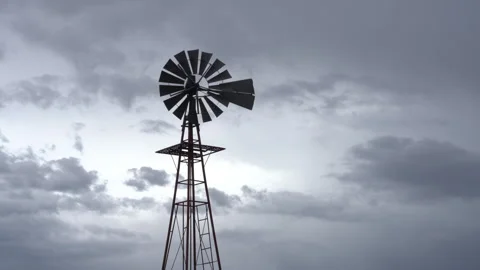 Real Time of a stationary old windmill and rain clouds in the American west Video stock 170675288