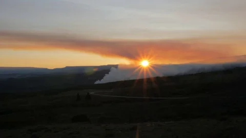 Real time sunset over a distant forest fire. Stock Footage 81086098