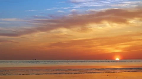 Real-Time Sunset Over Rippling Sea Horizon Descent and Coastal Stillness Stock Footage 312920673