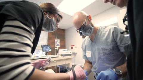 Real time video as 3 dentists operating 스톡 동영상 127001054