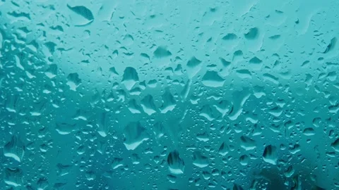 Real-time video. Clean blue raindrops on glass close-up. Trickles of raindrops Stock Footage 200363902