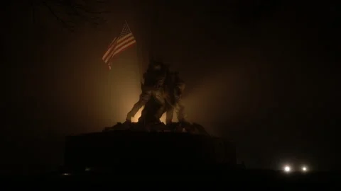 Real time wide shot of a backlit U.S. Marine Corps War Memorial in fog at night Stock Footage 140152429