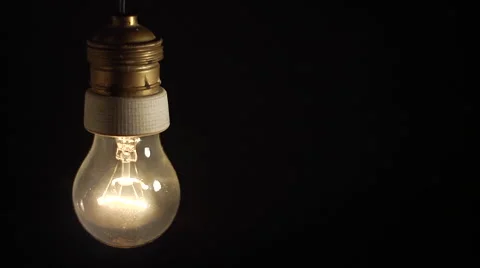Real tungsten lamp blinks on a black background Stock Footage 47619980