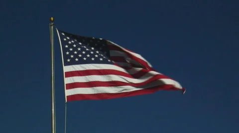 Real U.S.A. flag flies from flagpole in strong breeze Video stock 106138
