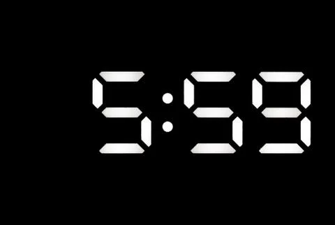 Real white led digital clock on black background Stock Photos