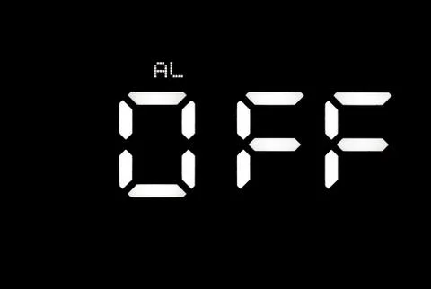 Real white led digital clock on black background Stock Photos