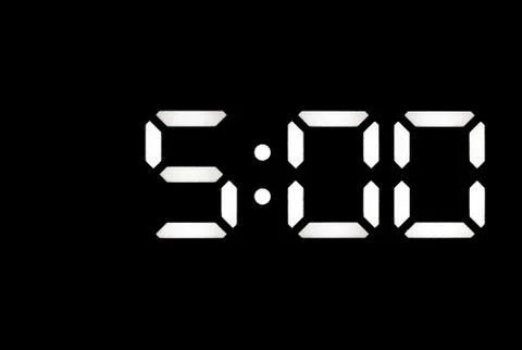 Real white led digital clock on black background Stock Photos