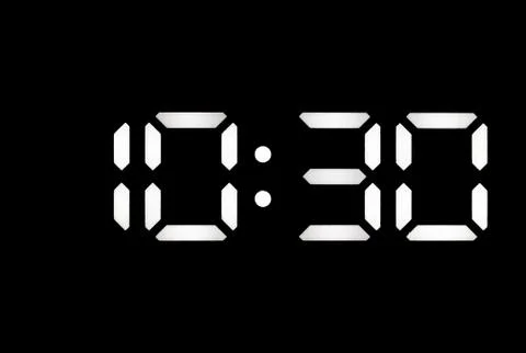 Real white led digital clock on black background Stock Photos
