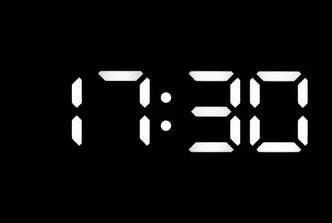 Real white led digital clock on black background Stock Photos