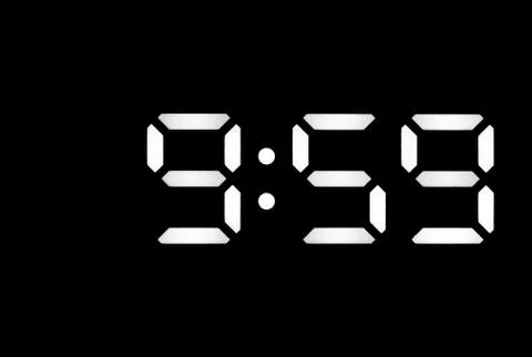 Real white led digital clock on black background Stock Photos