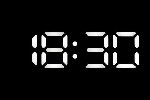 Real white led digital clock on black background Stock Photos