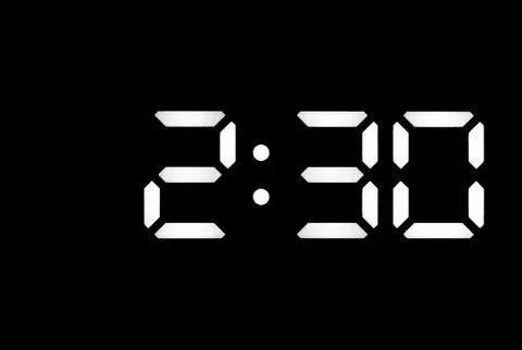Real white led digital clock on black background Stock Photos