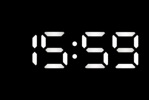 Real white led digital clock on black background Stock Photos