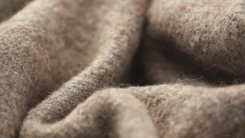 Real Wool knitted background. Natural beige color wool mohair clothes texture Stock Footage 329801478