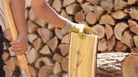 Real worker Chopping Firewood with an ax outdoors Stock Footage 90191956