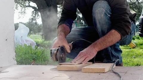 Real worker cuts a tile on the construction site, FHD Stock Footage 143486476
