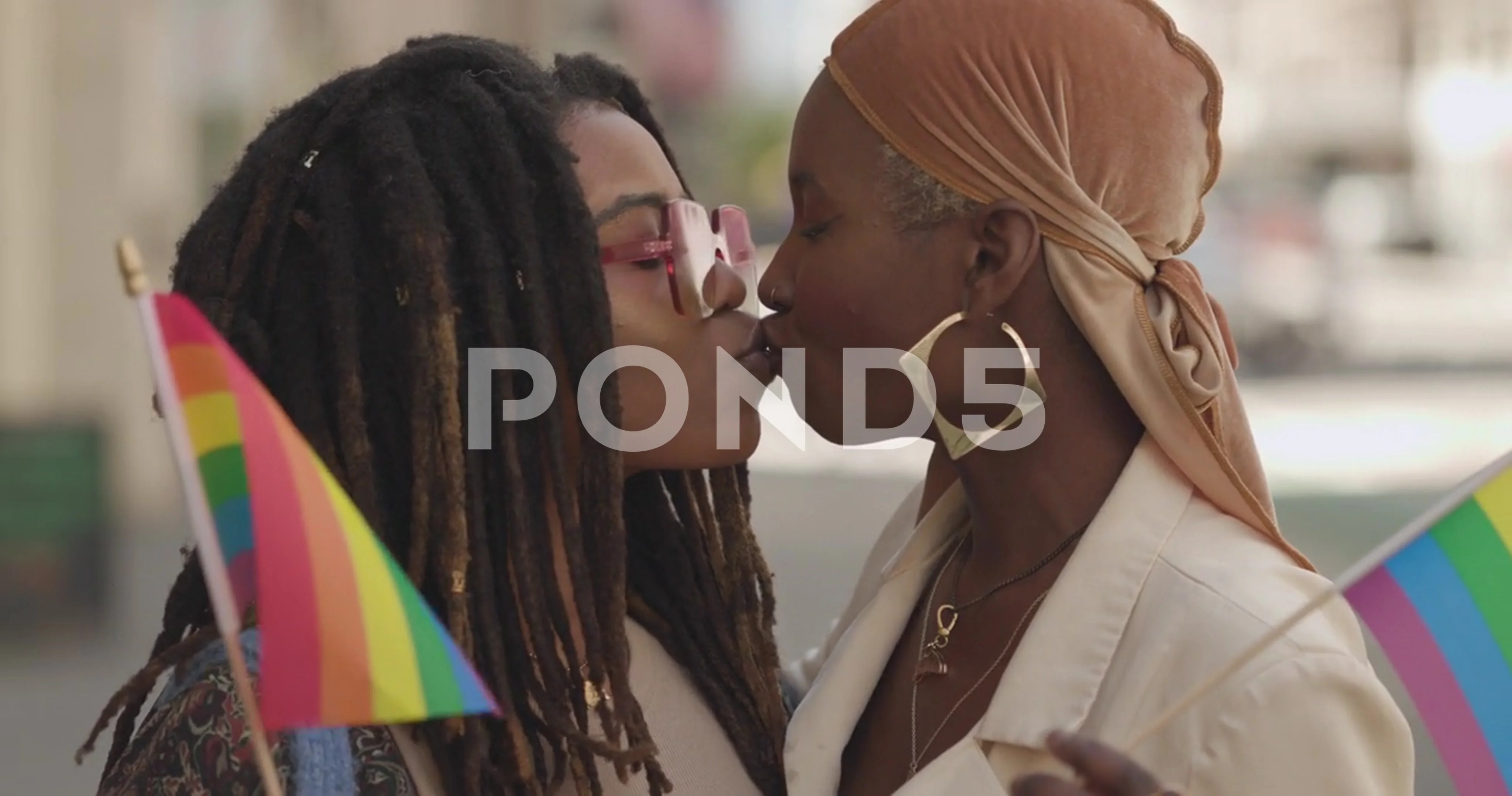 ReaLGBTQ black women same sex couple portrait on city street kissing slow  motion