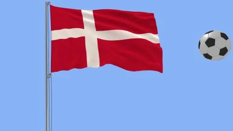 Realistic fluttering flag of Denmark and soccer ball flying around on a blue Illustrazione stock
