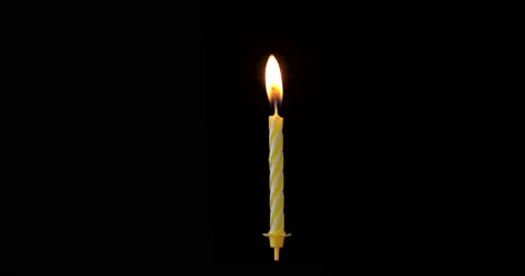 Realistic full-sized single yellow birthday candlelight isolated on black back Stock Footage 141727153
