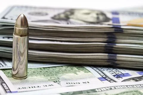 Realistic gun bullet and stack of usd money Stock Photos
