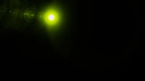 Realistic Len flare glow light effect on black background. Optical flares ove Stock Illustration