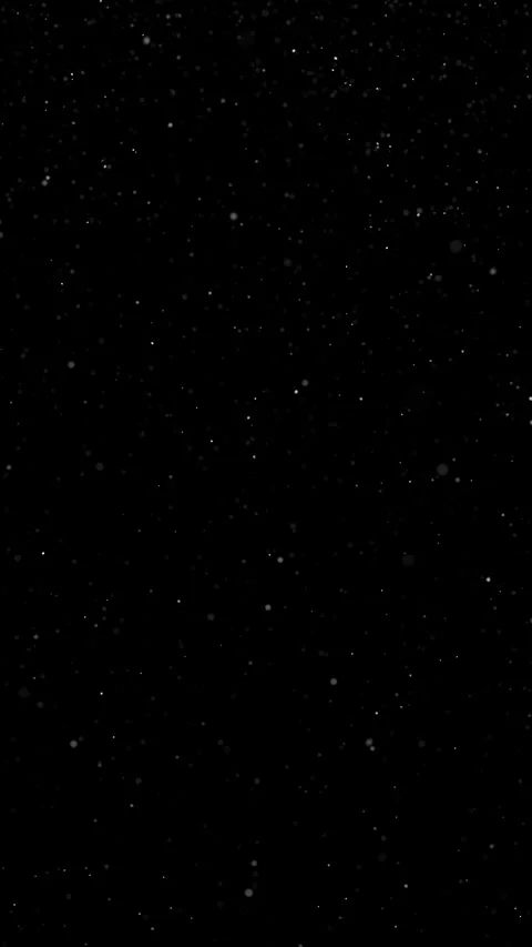 Realistic looped snowflakes falling on clean black vertical background Видео 338105136