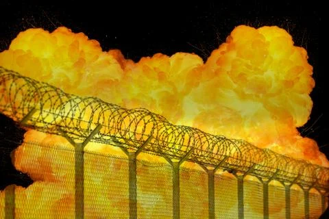 Realistic orange fire explosion behind restricted area barbed wire fence Stock Photos