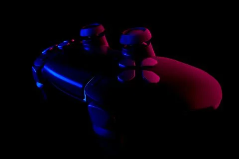 Realistic video game controller in neon lights on black noir background Stock Illustration