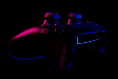 Realistic video game controller in neon lights on black noir background Stock Illustration