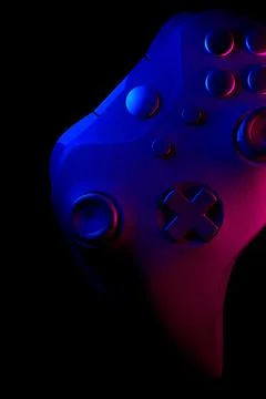 Realistic video game controller in neon lights on black noir background Stock Illustration