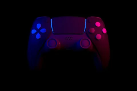 Realistic video game controller in neon lights on black noir background Stock Illustration