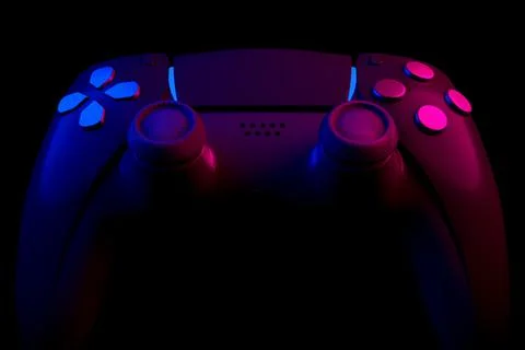 Realistic video game controller in neon lights on black noir background Stock Illustration
