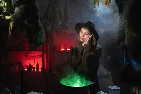 Realistic witch brewing a potion in cauldron showing sleep gesture. Blend of  Stock Photos