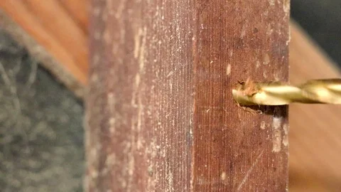 A realtime close up shot of making a hole in a wooden block using a drill Video stock 96078036